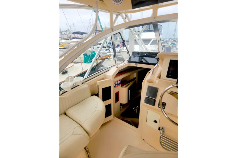 Slide: The Image of Interior view of 2009 Grady-White Express 330 boat, featuring helm and seating area. - 16