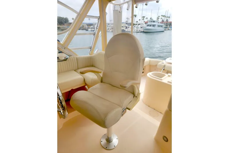 Slide: The Image of Captain's chair on 2009 Grady-White Express 330 boat, overlooking marina. - 17