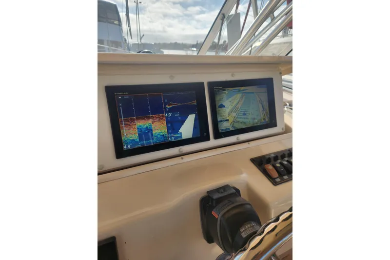 Slide: The Image of Dashboard of a 2009 Grady-White Express 330 boat with navigation screens. - 20
