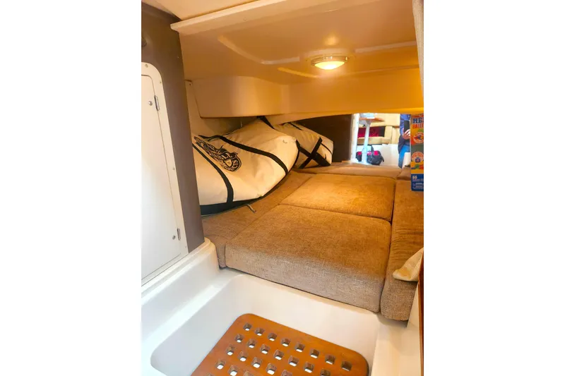 Slide: The Image of Interior cabin of 2009 Grady-White Express 330 boat with cozy bedding and storage. - 25