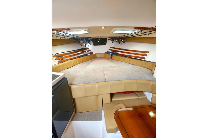 Slide: The Image of Interior of 2009 Grady-White Express 330 boat with cozy seating and fishing rod storage. - 29