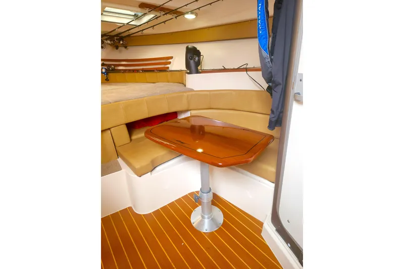 Slide: The Image of Interior of 2009 Grady-White Express 330 boat with cozy seating and wooden table. - 30