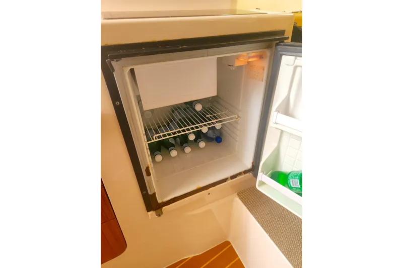 Slide: The Image of Open fridge on 2009 Grady-White Express 330 boat, stocked with bottled beverages. - 31