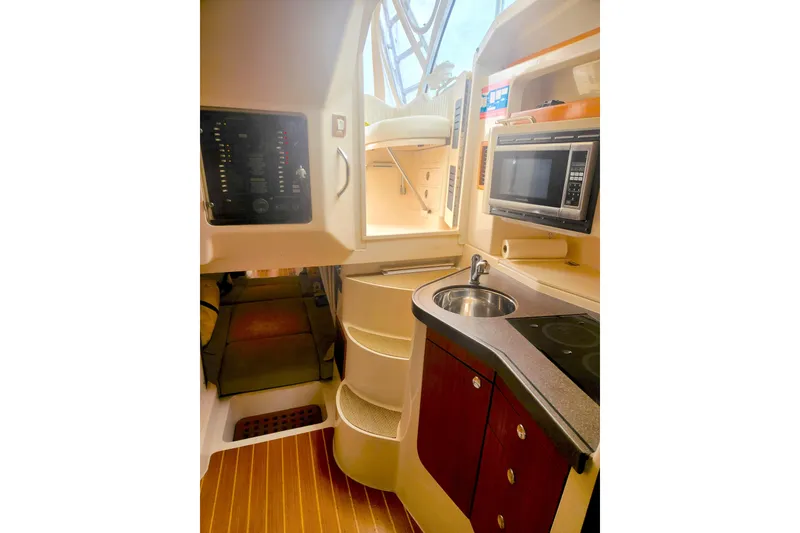 Slide: The Image of 2009 Grady-White Express 330 boat interior with kitchenette, microwave, and sink. - 32