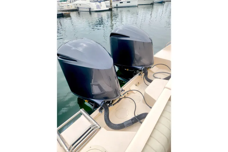Slide: The Image of Twin outboard motors on a 2009 Grady-White Express 330 boat docked at a marina. - 5