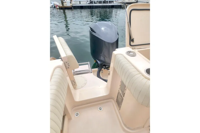 Slide: The Image of 2009 Grady-White Express 330 boat interior with outboard motor, docked on calm water. - 6