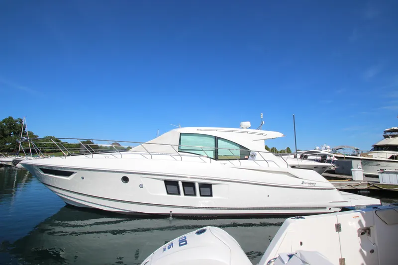 Slide: The Image of 2014 Cruisers Yachts 45 Cantius docked under clear blue sky. - 1