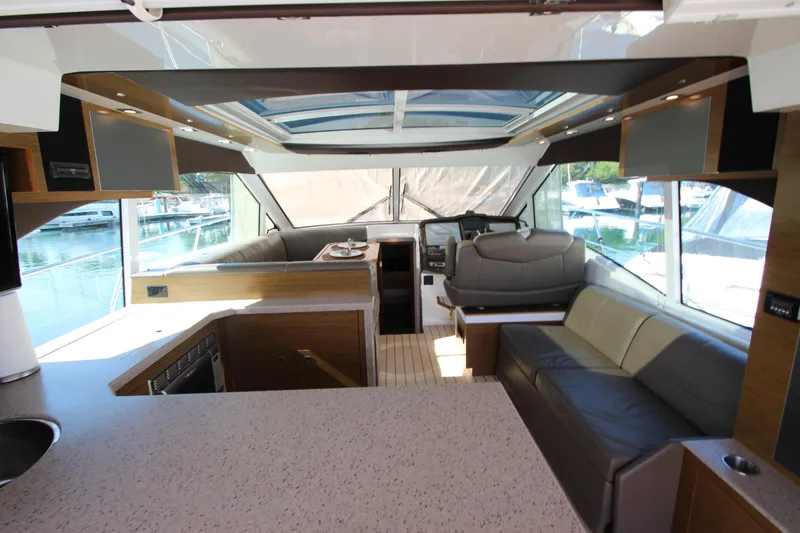 Slide: The Image of Luxurious interior of 2014 Cruisers Yachts 45 Cantius with modern seating and panoramic windows. - 13