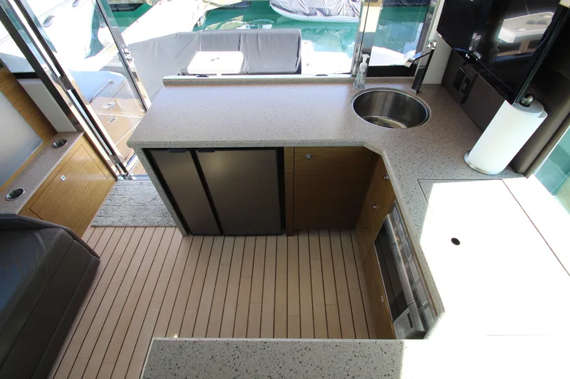 Slide: The Image of Luxurious 2014 Cruisers Yachts 45 Cantius galley with modern appliances and sleek countertops. - 16