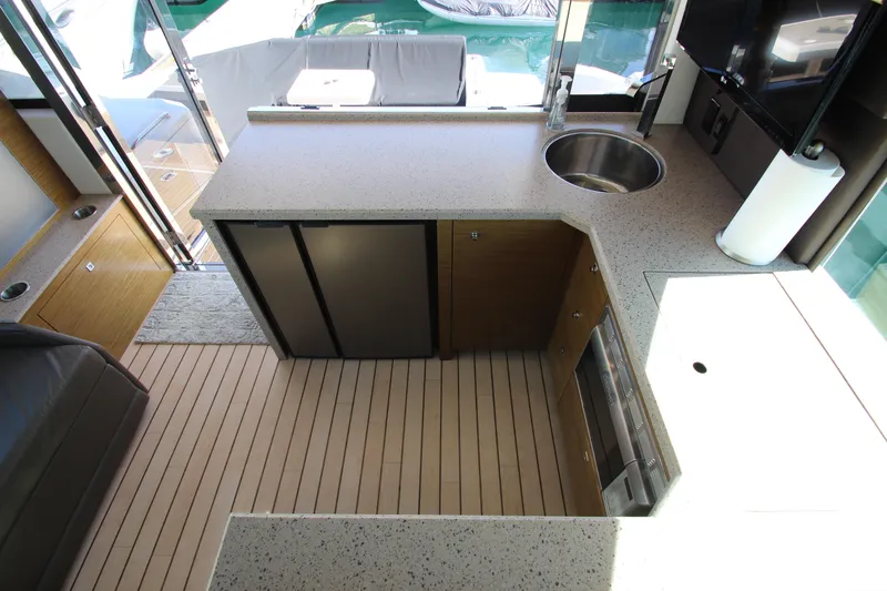 Slide: The Image of 2014 Cruisers Yachts 45 Cantius galley with modern appliances and sleek countertops. - 17