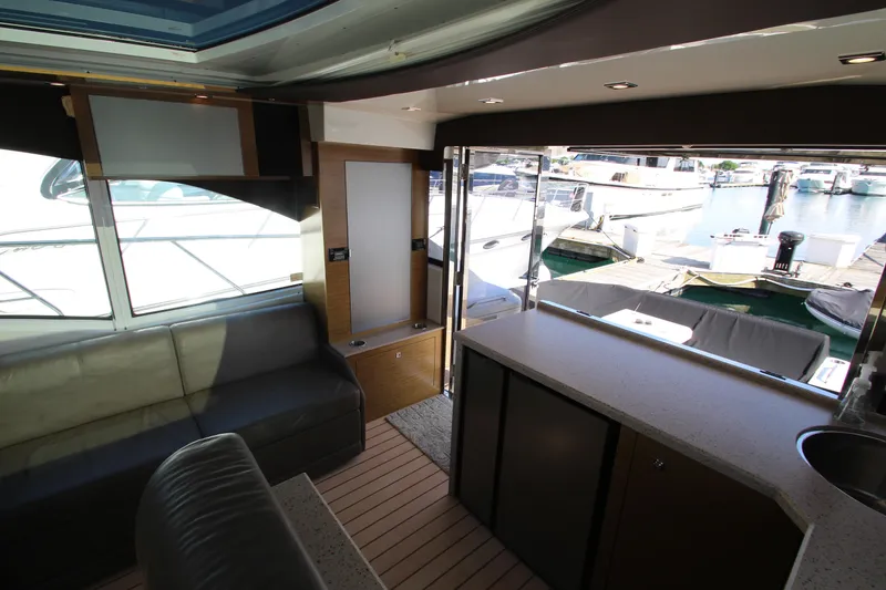 Slide: The Image of Interior of 2014 Cruisers Yachts 45 Cantius with marina view through open doors. - 19