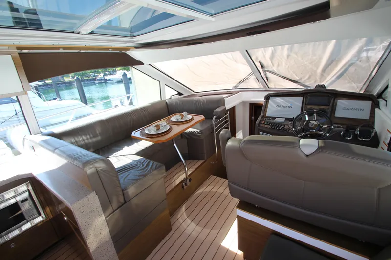 Slide: The Image of Interior of 2014 Cruisers Yachts 45 Cantius with helm, seating, and dining area. - 21