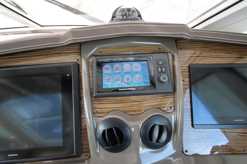 Slide: The Image of Dashboard of 2014 Cruisers Yachts 45 Cantius with navigation screens and controls. - 27