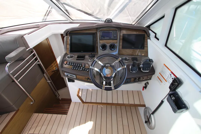 Slide: The Image of Helm of 2014 Cruisers Yachts 45 Cantius with modern navigation controls and dual displays. - 28