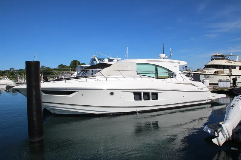 Slide: The Image of 2014 Cruisers Yachts 45 Cantius docked in a marina under clear blue skies. - 3
