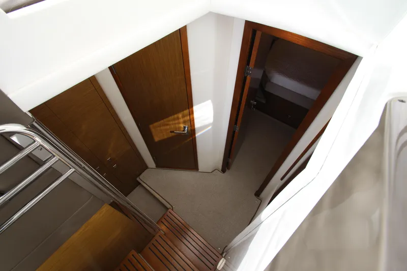 Slide: The Image of 2014 Cruisers Yachts 45 Cantius interior with wooden doors and carpeted flooring. - 38