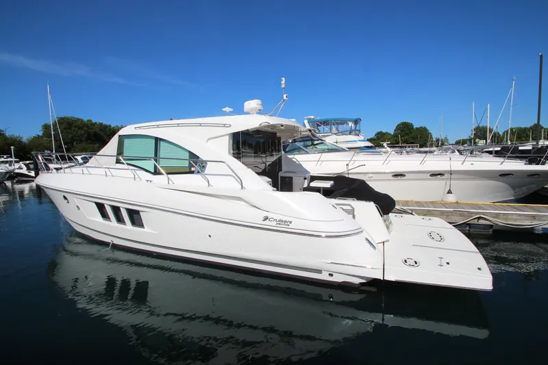 Slide: The Image of 2014 Cruisers Yachts 45 Cantius docked in a marina under clear blue skies. - 4