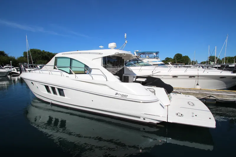 Slide: The Image of 2014 Cruisers Yachts 45 Cantius docked in a marina under clear blue skies. - 5