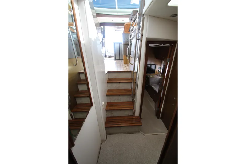 Slide: The Image of Interior staircase of 2014 Cruisers Yachts 45 Cantius, featuring wooden steps and modern design. - 50