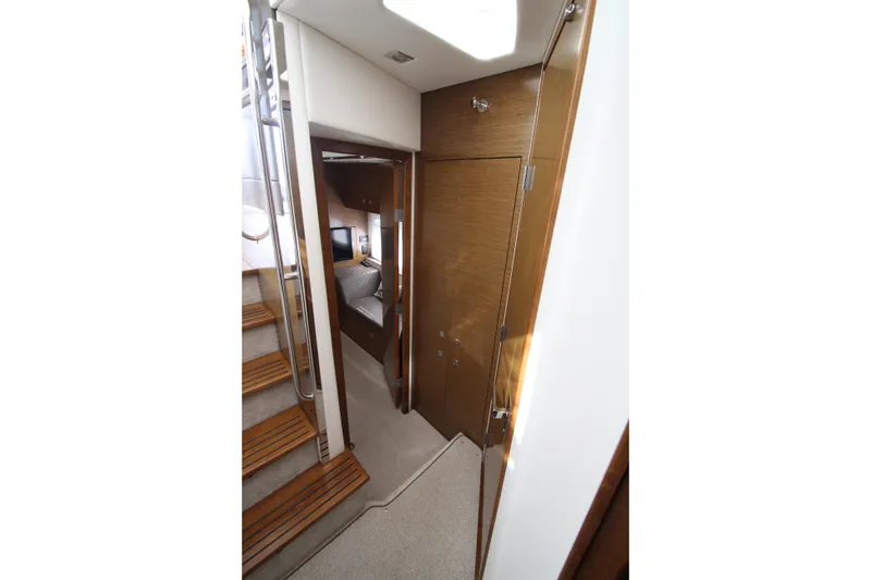 Slide: The Image of Interior view of 2014 Cruisers Yachts 45 Cantius, featuring wooden stairs and cozy cabin. - 51