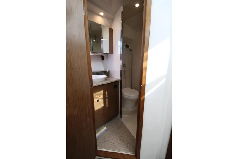 Slide: The Image of Luxurious bathroom in 2014 Cruisers Yachts 45 Cantius, featuring modern fixtures and elegant wood finishes. - 52
