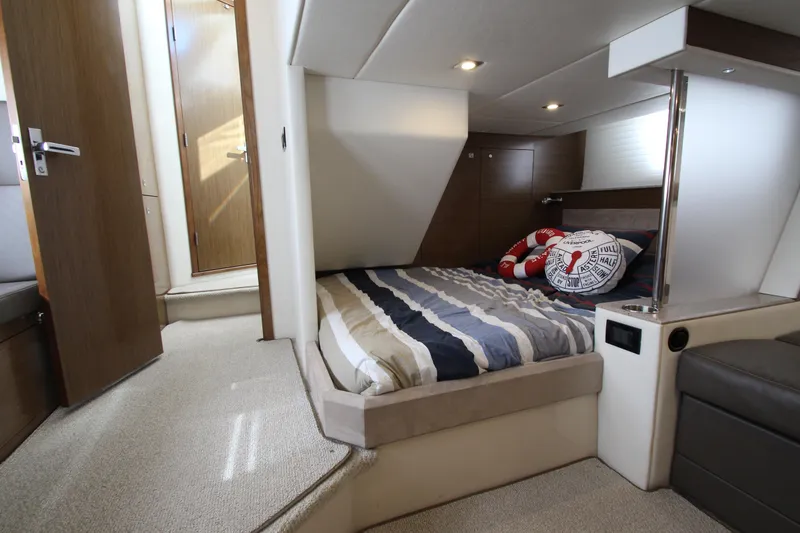 Slide: The Image of Luxurious 2014 Cruisers Yachts 45 Cantius cabin interior with cozy bed and nautical decor. - 57