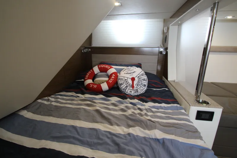 Slide: The Image of Cozy cabin interior of 2014 Cruisers Yachts 45 Cantius with striped bedding and nautical decor. - 66