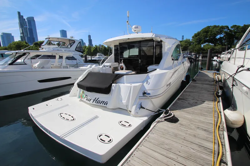 Slide: The Image of 2014 Cruisers Yachts 45 Cantius docked in a marina with city skyline. - 7