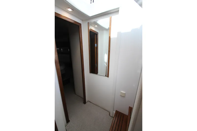 Slide: The Image of Interior hallway of 2014 Cruisers Yachts 45 Cantius with mirror and wooden accents. - 70
