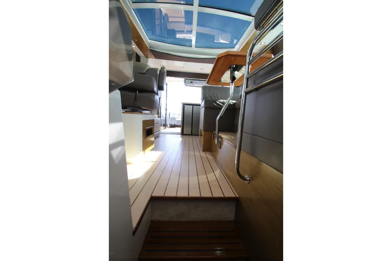 Slide: The Image of Interior view of 2014 Cruisers Yachts 45 Cantius, featuring sleek wood flooring and modern seating. - 71