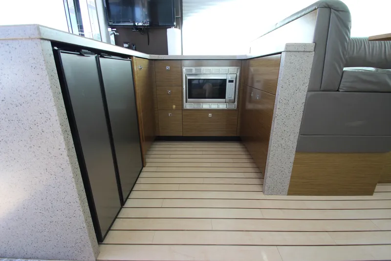 Slide: The Image of Modern kitchen area in 2014 Cruisers Yachts 45 Cantius with sleek appliances and wood flooring. - 73
