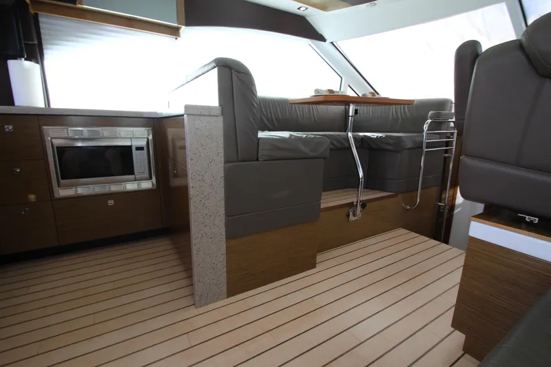 Slide: The Image of Interior of 2014 Cruisers Yachts 45 Cantius with modern seating and kitchen area. - 74