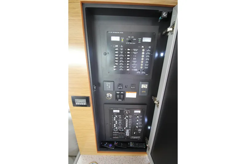 Slide: The Image of Electrical panel inside 2014 Cruisers Yachts 45 Cantius, showcasing control switches and meters. - 75