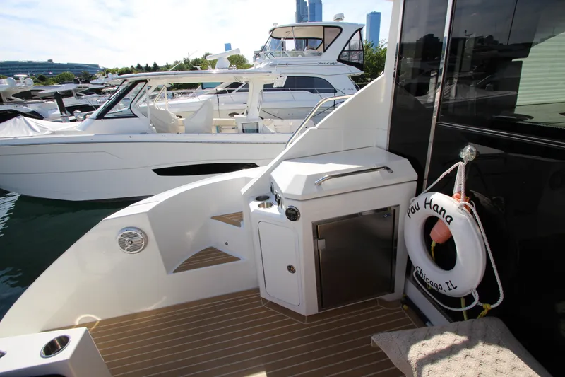 Slide: The Image of 2014 Cruisers Yachts 45 Cantius docked, featuring deck area with life preserver and storage. - 78