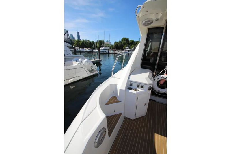 Slide: The Image of 2014 Cruisers Yachts 45 Cantius docked, showcasing sleek deck design and marina view. - 79