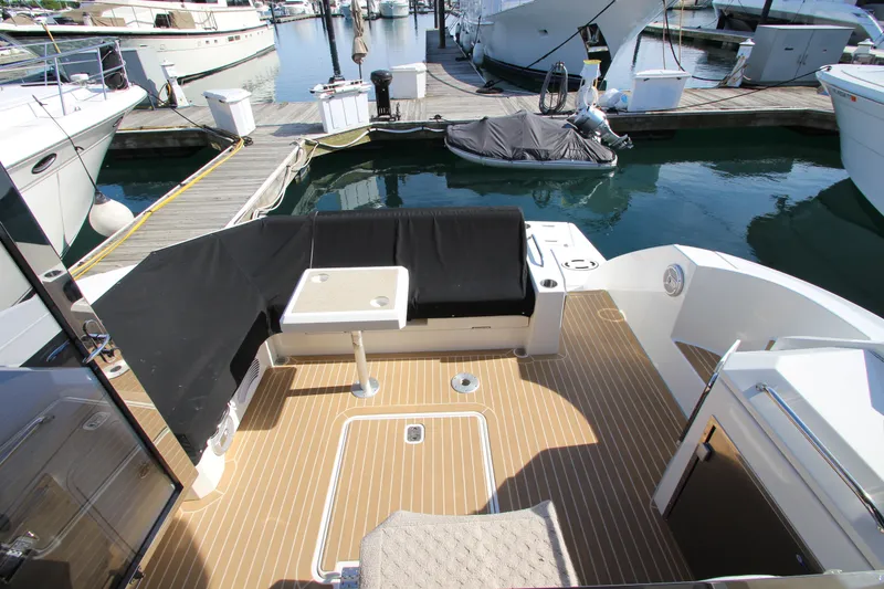 Slide: The Image of 2014 Cruisers Yachts 45 Cantius deck with seating and table at marina. - 8