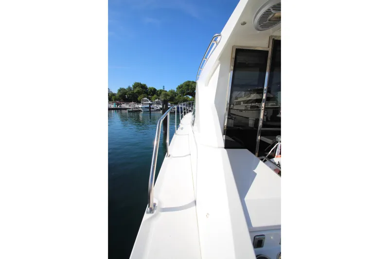 Slide: The Image of Side view of 2014 Cruisers Yachts 45 Cantius on calm water. - 80