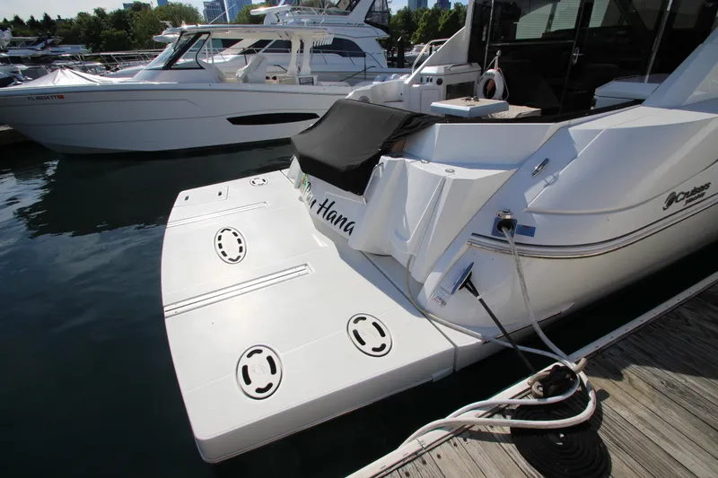 Slide: The Image of 2014 Cruisers Yachts 45 Cantius docked, showcasing sleek design and spacious swim platform. - 83