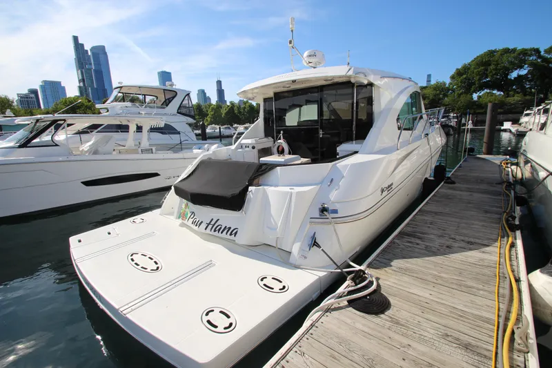 Slide: The Image of 2014 Cruisers Yachts 45 Cantius docked in a marina with city skyline backdrop. - 84