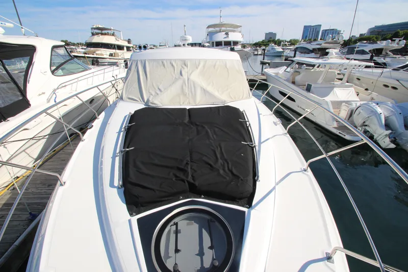 Slide: The Image of 2014 Cruisers Yachts 45 Cantius docked at marina, surrounded by other boats. - 89