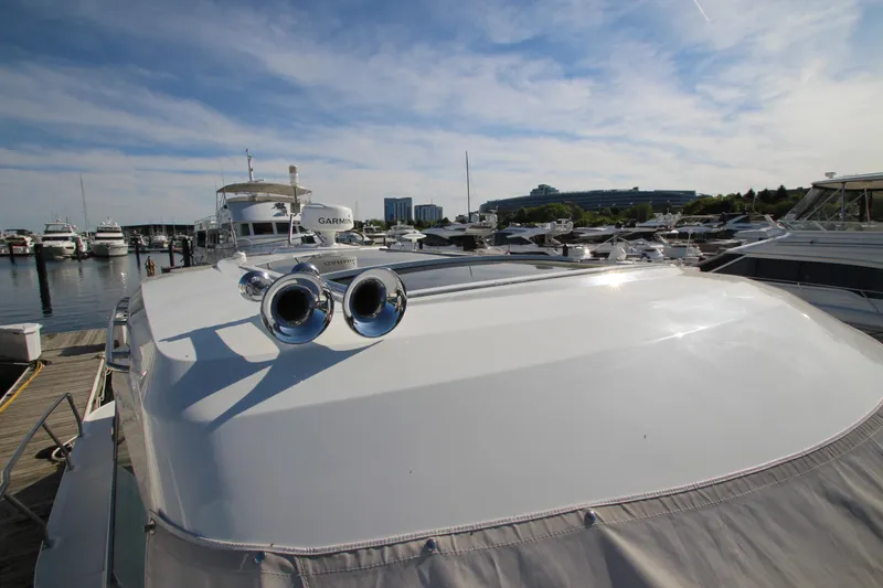 Slide: The Image of 2014 Cruisers Yachts 45 Cantius docked at marina under clear blue sky. - 90