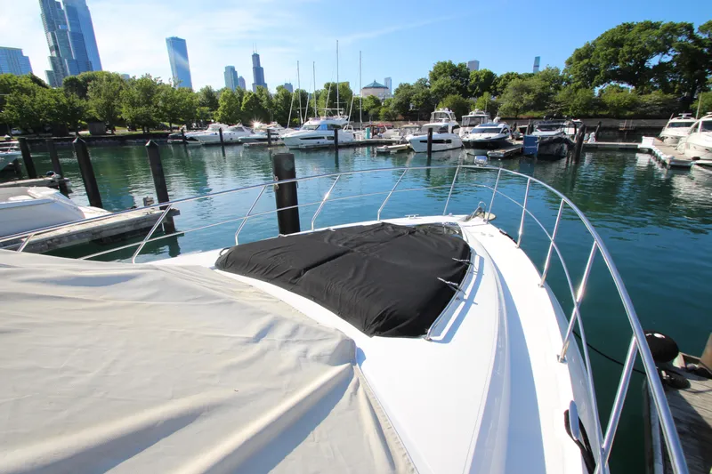 Slide: The Image of 2014 Cruisers Yachts 45 Cantius docked in a scenic marina with city skyline. - 91