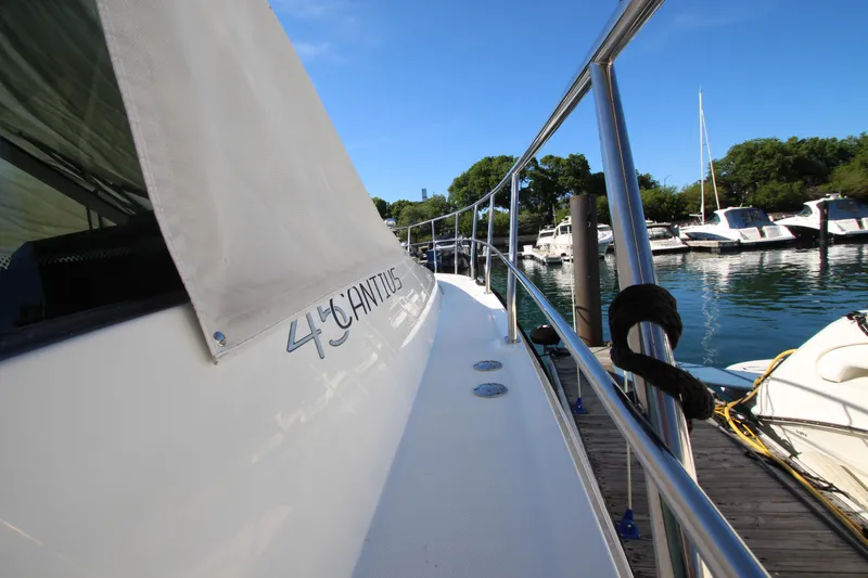 Slide: The Image of 2014 Cruisers Yachts 45 Cantius docked, showcasing sleek design and marina view. - 92