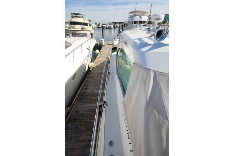 Slide: The Image of 2014 Cruisers Yachts 45 Cantius docked at marina, side view with clear sky. - 93