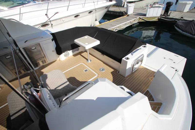 Slide: The Image of 2014 Cruisers Yachts 45 Cantius cockpit with seating, table, and dock view. - 95