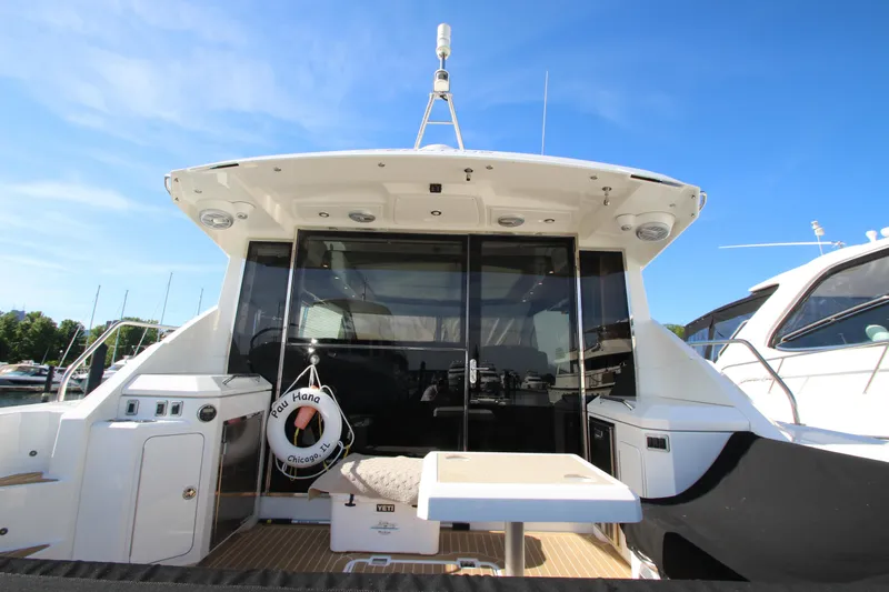 Slide: The Image of 2014 Cruisers Yachts 45 Cantius, rear view with deck and seating area. - 96