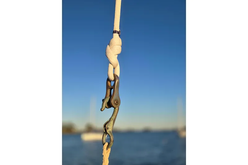 Slide: The Image of Close-up of a rope and shackle on a 1970 Hinckley Bermuda 40 sailboat. - 102