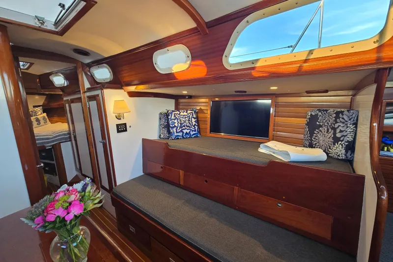 Slide: The Image of Interior of a 1970 Hinckley Bermuda 40 yacht with cozy seating and elegant wood finishes. - 104