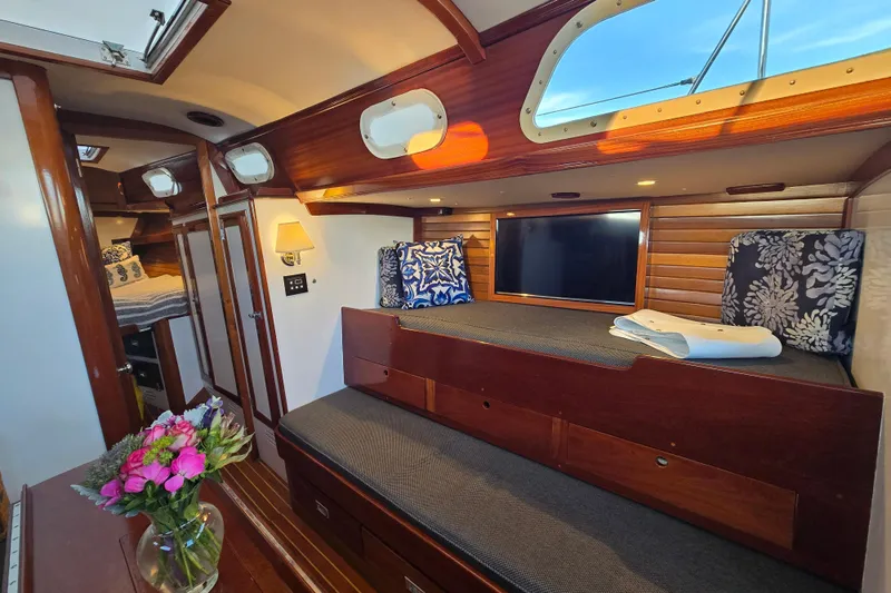 Slide: The Image of Interior of a 1970 Hinckley Bermuda 40 yacht with cozy seating and elegant wood finishes. - 105