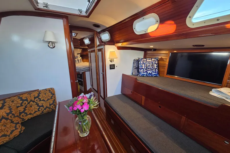 Slide: The Image of Interior of a 1970 Hinckley Bermuda 40 yacht with elegant wood finish and cozy seating. - 106